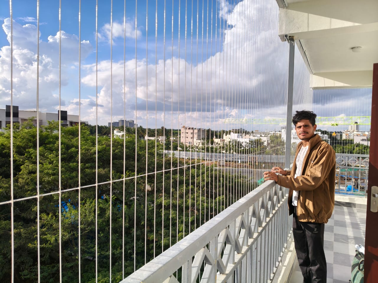 Stainless steel invisible grills securely installed on modern balconies for maximum safety
